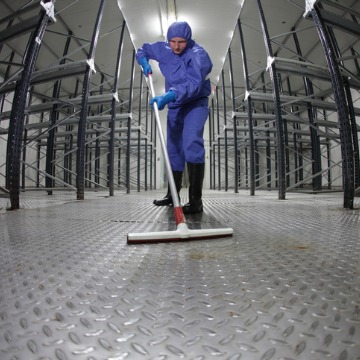 A Janitor in Pekin IL mopping the floor of a manufacturing facility