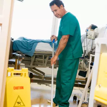 A professional cleaner is seen mopping. Corporate Clean is the best of the Commercial Cleaning Companies in Peoria County IL.