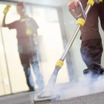 Professional cleaners are seen at work. Corporate Clean offers Business Cleaning.