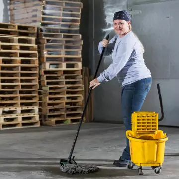 A cleaner is seen mopping an industrial space. Corporate Clean offers industrial cleaning services in Pekin IL.