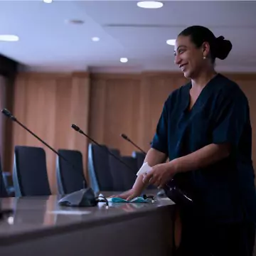 A woman is seen cleaning a conference room. Corporate Clean is the best of the office cleaners in East Peoria IL.