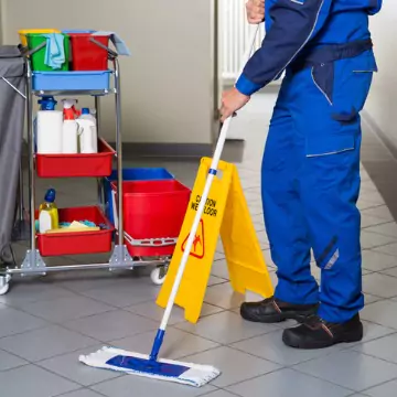 A cleaner is seen cleaning an office. The best corporate cleaning in Tazewell County IL is done by Corporate Clean.