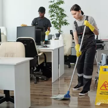 A cleaner is seen cleaning an office. The best office cleaning in central Illinois is done by Corporate Clean.